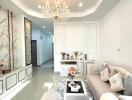 Spacious and elegantly designed living room with chandelier and modern furniture