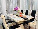 Modern dining room with a stylish table and chairs, decorated with flowers and tableware