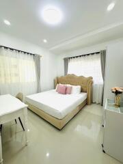 Bright bedroom with double bed and desk