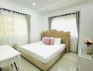 Bright bedroom with double bed and desk