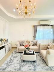 Elegant living room with chandelier and white sofas