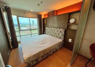 Modern bedroom with large window and city view