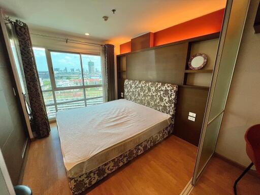 Modern bedroom with large window and city view