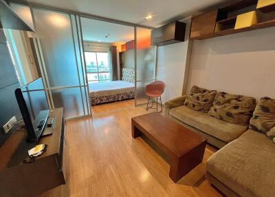 A modern living room with a view into the bedroom