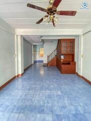 Main living area with blue tile floor and ceiling fan