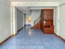 Main living area with blue tile floor and ceiling fan