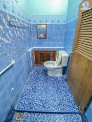 Bathroom with blue tiles and toilet