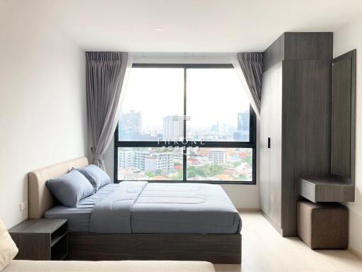 Modern bedroom with large window and city view