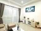 Spacious modern living room with beige furniture, a white coffee table, and large windows with curtains