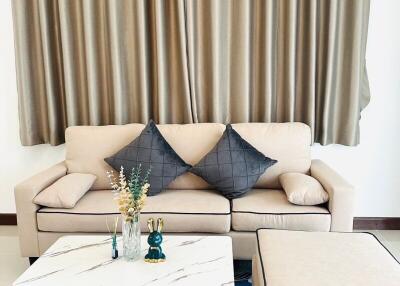 Cozy living room with a beige sofa and curtains