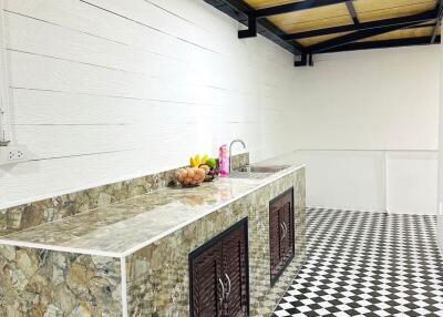 modern kitchen with marble countertop and checkered floor