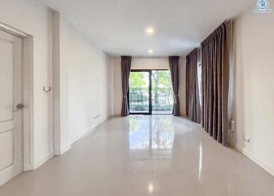 Spacious living room with large windows and balcony access