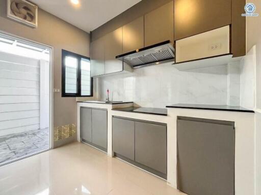 Modern kitchen with gray and white cabinetry and tile backsplash