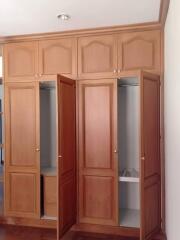 wooden wardrobe with multiple doors, some open