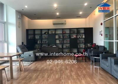 Spacious living room with modern furniture and large bookshelf