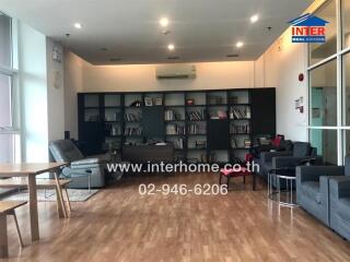 Spacious living room with modern furniture and large bookshelf