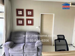 Living room with grey sofa and office chair