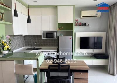 Modern kitchen and living area with office desk