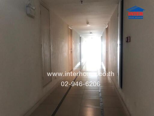 Hallway with tile flooring and lighting