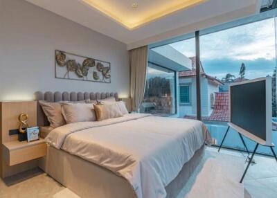 Modern bedroom with large windows and a double bed