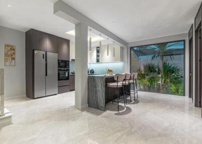 Modern kitchen with a dining area and large windows