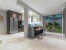 Modern kitchen with a dining area and large windows