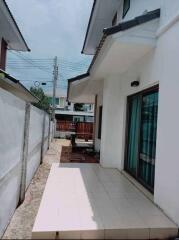 Outdoor area with tiled walkway and glass sliding door