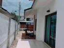 Outdoor area with tiled walkway and glass sliding door