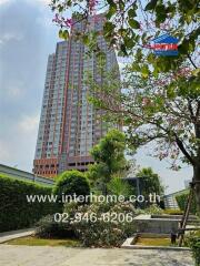 High-rise apartment building with surrounding greenery