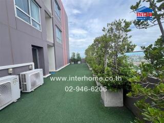 Outdoor area with greenery and air conditioning units