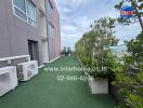 Outdoor area with greenery and air conditioning units