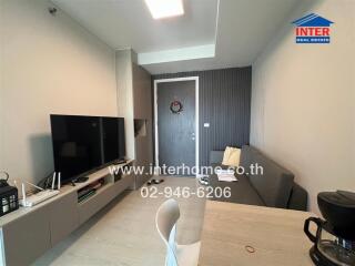 Modern living room with television, sofa, and dining area