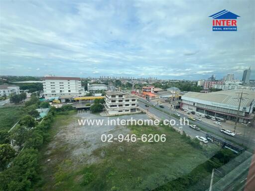 Aerial view of surroundings including commercial and residential buildings