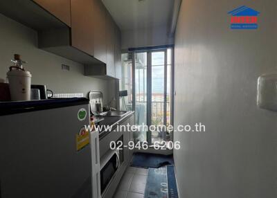 Modern kitchen with appliances and balcony access