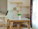 Modern dining room with wooden furniture and contemporary shelving