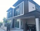 Modern two-story house with balconies and garage