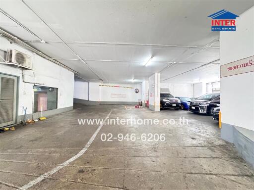 Indoor parking garage with several parked vehicles