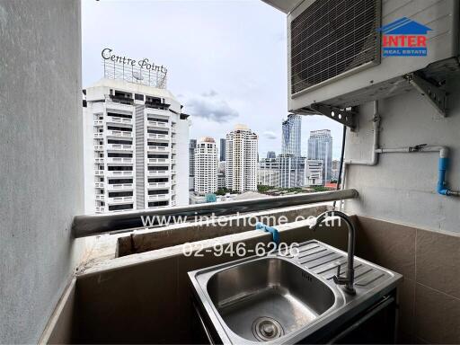 Small balcony with sink and city view