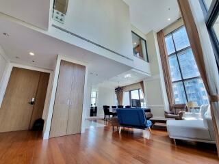 Modern living room with high ceilings and large windows