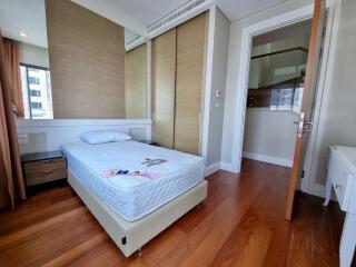 modern bedroom with single bed and wooden flooring