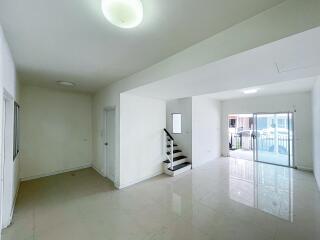 Spacious living area with staircase and balcony