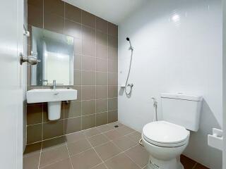 Modern bathroom with sink, mirror, toilet, and shower