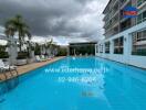 Outdoor swimming pool with surrounding lounge chairs and greenery