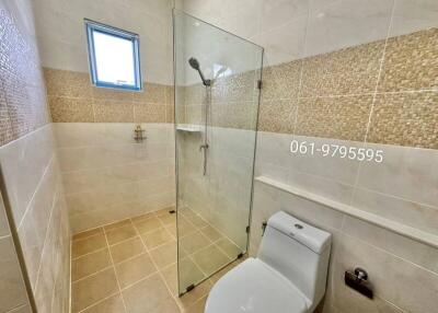 Bathroom with glass shower enclosure and toilet