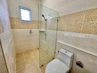 Bathroom with glass shower enclosure and toilet