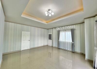 Spacious living room with modern lighting and large window