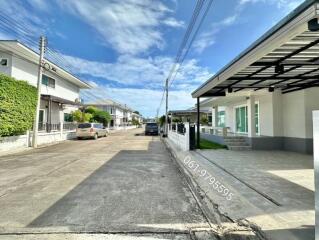 View of residential street with houses and a driveway