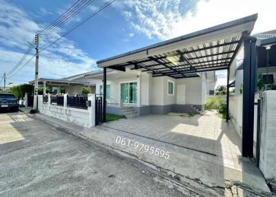 Exterior view of a single-story house with a carport