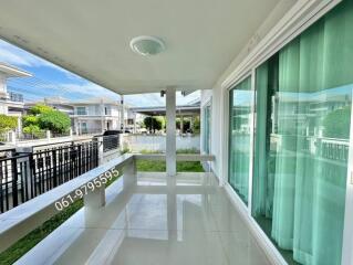 Spacious balcony with greenery view and glass doors