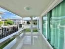 Spacious balcony with greenery view and glass doors